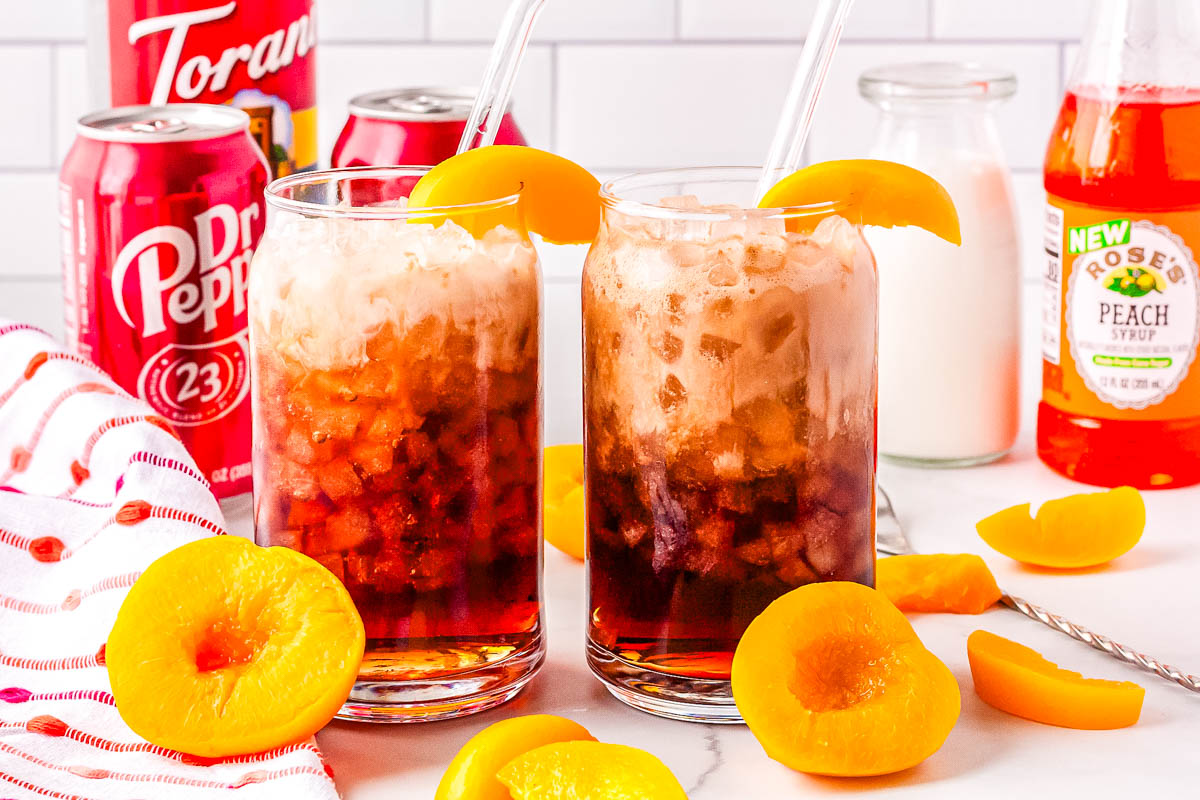 Two glasses of Life's A Peach drink on a counter.