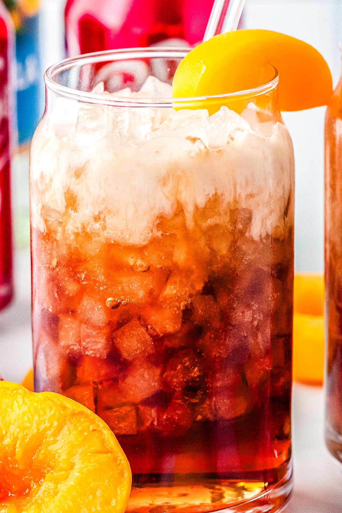 A Life's a Peach copycat recipe in a clear glass with pebble ice.