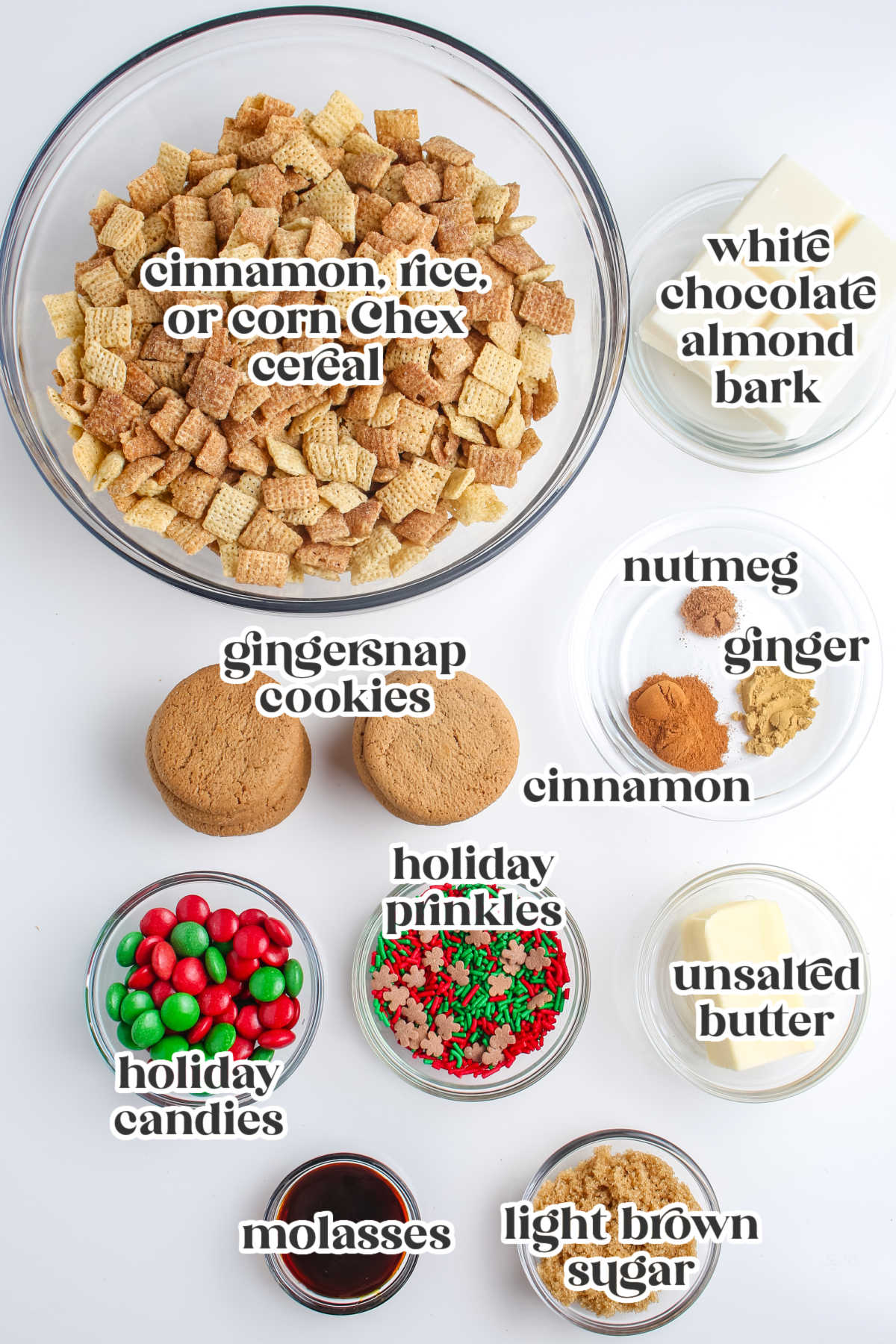 Flat lay of labeled ingredients for Gingerbread Chex Mix including Chex cereal, gingersnap cookies, white chocolate almond bark, spices, butter, molasses, sprinkles, and holiday candies.