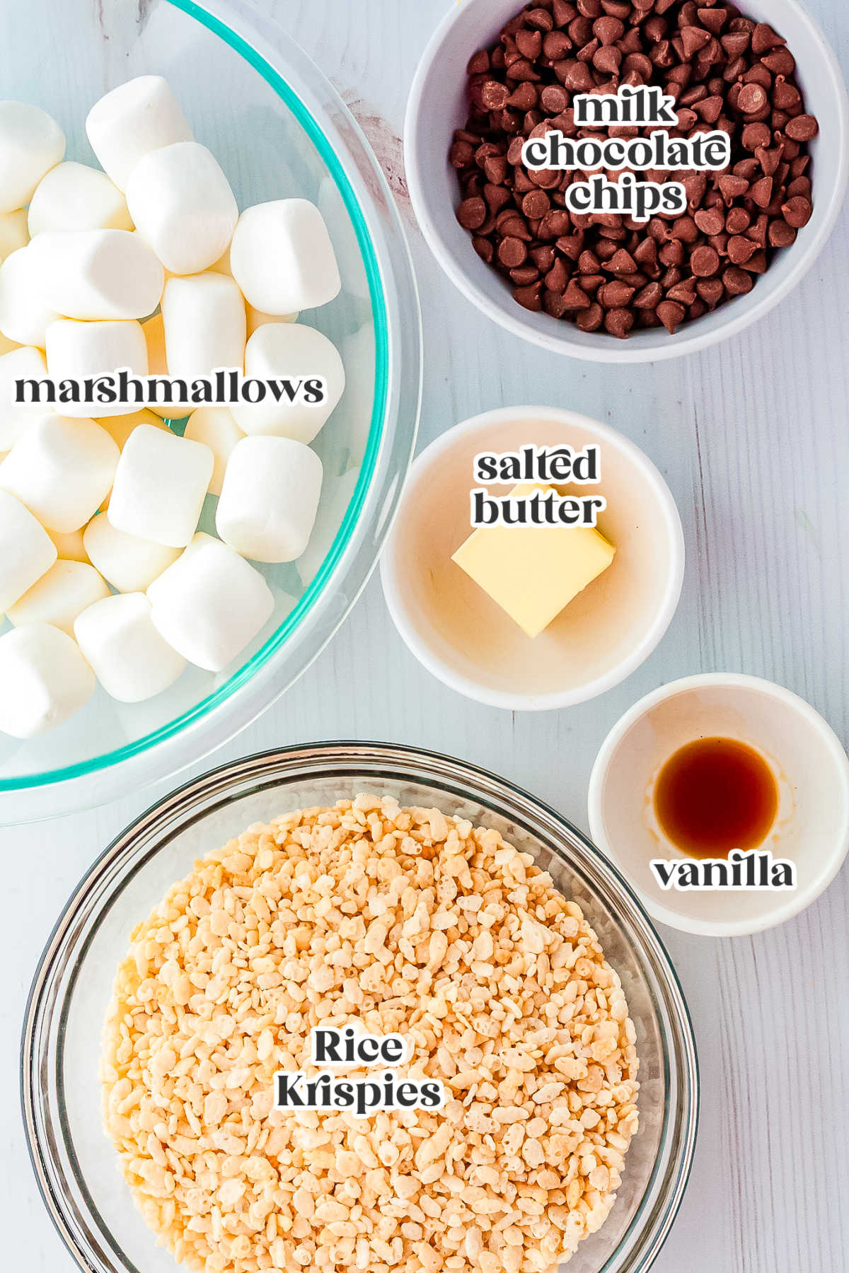Ingredients for chocolate dipped Rice Crispy treats laid out in bowls.
