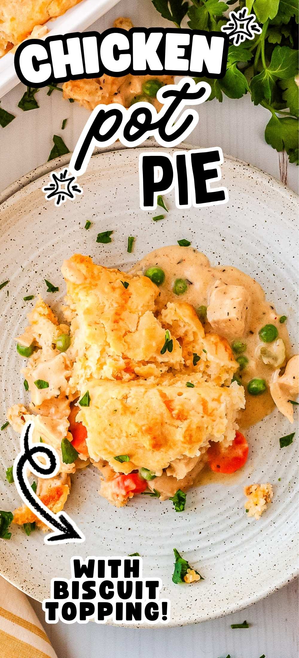 Chicken pot pie with biscuit topping served on plate with creamy filling and golden cheddar biscuit crust.