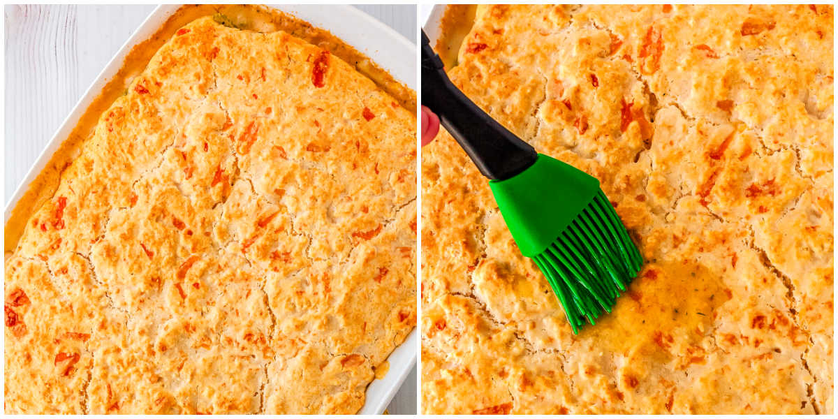 Golden baked chicken pot pie with biscuit crust being brushed with garlic herb butter.