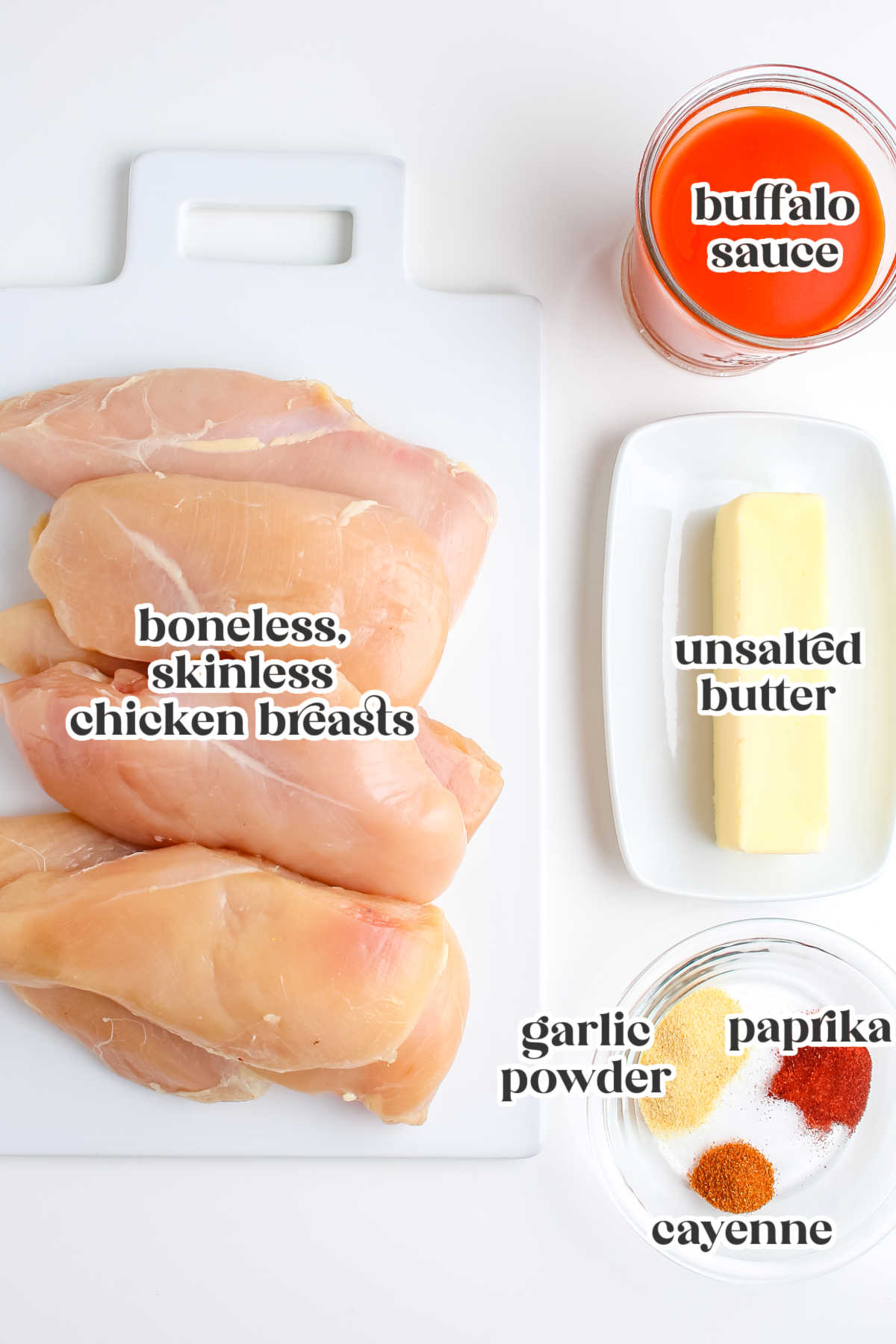 Ingredients for grilled buffalo chicken including chicken breasts, buffalo sauce, butter, garlic powder, paprika, and cayenne pepper.